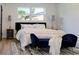 A modern bedroom features a plush bed, dark-trimmed doors, and lots of natural light from the window at 550 Eagle Dr, Daytona Beach, FL 32117