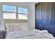 Cozy bedroom with a bed with white and pink pillows, and a large closet with black folding doors at 550 Eagle Dr, Daytona Beach, FL 32117
