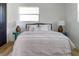 Bedroom featuring natural light, neutral bedding, hardwood floors, and dark-trimmed doors at 550 Eagle Dr, Daytona Beach, FL 32117