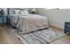 Cozy bedroom featuring a bed with soft, neutral bedding and hardwood floors at 550 Eagle Dr, Daytona Beach, FL 32117