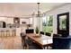 Open-concept dining room with a wooden table, upholstered chairs, and kitchen view at 550 Eagle Dr, Daytona Beach, FL 32117