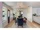 Dining room featuring a table, chairs, modern chandelier, with natural light and view to the living room at 550 Eagle Dr, Daytona Beach, FL 32117