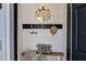 Bright entryway boasts a light wood bench, a black 