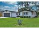 Charming single Gathering home with a gray two car garage and a well kept lawn at 550 Eagle Dr, Daytona Beach, FL 32117