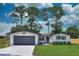 Charming single Gathering home with a gray two car garage and a manicured lawn at 550 Eagle Dr, Daytona Beach, FL 32117