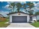 Oversized two car garage with a modern door and stylish exterior accents at 550 Eagle Dr, Daytona Beach, FL 32117