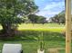 Picturesque golf course view showcasing lush green grass and mature trees, seen from the patio at 550 Eagle Dr, Daytona Beach, FL 32117