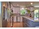 Gourmet kitchen featuring stainless steel appliances, grey backsplash, and grey and white cabinets at 550 Eagle Dr, Daytona Beach, FL 32117