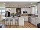 Modern kitchen with white cabinets, gray backsplash, stainless steel appliances, and pendant lighting at 550 Eagle Dr, Daytona Beach, FL 32117
