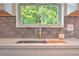 Modern quartz kitchen sink and counter with tiled backsplash and bronze fixtures at 550 Eagle Dr, Daytona Beach, FL 32117