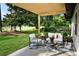 Outdoor patio with golf course views, modern seating arrangement, and a sunshade at 550 Eagle Dr, Daytona Beach, FL 32117