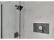 Modern shower with sleek tiles, black hardware, and a built-in niche for storage and decor at 550 Eagle Dr, Daytona Beach, FL 32117
