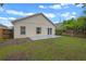View of the back of the house with a small concrete patio and fenced backyard at 5559 Pats Pt, Winter Park, FL 32792