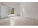 This is an empty bedroom with tile flooring and natural lighting from a window at 5559 Pats Pt, Winter Park, FL 32792