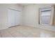 This is an empty bedroom with tile flooring and a window overlooking the backyard at 5559 Pats Pt, Winter Park, FL 32792