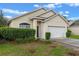 Inviting single-story home featuring a two-car garage and mature landscaping at 5559 Pats Pt, Winter Park, FL 32792