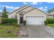 Charming single-story home with well-maintained landscaping and a two-car garage at 5559 Pats Pt, Winter Park, FL 32792