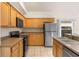 Well-equipped kitchen with modern appliances, wooden cabinets, and a double basin sink at 5559 Pats Pt, Winter Park, FL 32792