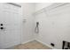 A basic laundry room with tile flooring, a shelf and hookups for a washer and dryer at 5559 Pats Pt, Winter Park, FL 32792