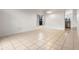 Spacious living room featuring neutral tile flooring, a window, and adjacent dining area at 5559 Pats Pt, Winter Park, FL 32792