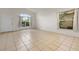 Bright and airy living room with tile flooring and large windows, creating an open feel at 5559 Pats Pt, Winter Park, FL 32792