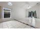 Well-lit living room with tile flooring, a ceiling fan, and sliding doors to the backyard at 5559 Pats Pt, Winter Park, FL 32792