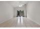 Bright living area with tile floors, a ceiling fan, and backyard access at 5559 Pats Pt, Winter Park, FL 32792
