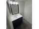 Bathroom with modern vanity featuring a white countertop, updated fixtures and dark gray flooring at 5930 Village Cir # Ge, Orlando, FL 32822