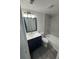 Modern bathroom featuring a vanity with a black cabinet, white countertop, and a bathtub with gray tiling at 5930 Village Cir # Ge, Orlando, FL 32822