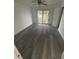 Spacious bedroom with a ceiling fan, sliding glass doors leading to a balcony, and new gray floors at 5930 Village Cir # Ge, Orlando, FL 32822