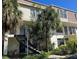 Charming multi-Gathering unit featuring a black staircase, well-maintained landscaping, and tropical palm trees at 5930 Village Cir # Ge, Orlando, FL 32822