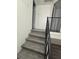 An interior staircase features stylish railings, hardwood floors, and new paint at 5930 Village Cir # Ge, Orlando, FL 32822