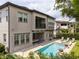 Gorgeous backyard featuring a sparkling pool, a cozy lounge area, and lush green landscaping at 682 Canopy Estates Dr, Winter Garden, FL 34787