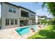 Spacious backyard featuring a luxurious pool, outdoor seating, and a covered patio at 682 Canopy Estates Dr, Winter Garden, FL 34787