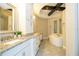 Modern bathroom featuring granite counters, double sinks, soaking tub, and a separate shower at 682 Canopy Estates Dr, Winter Garden, FL 34787