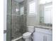 Bathroom featuring tiled shower, granite countertop, and white vanity for a clean aesthetic at 682 Canopy Estates Dr, Winter Garden, FL 34787