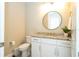 Bright half bath with granite countertop, white vanity, and neutral walls at 682 Canopy Estates Dr, Winter Garden, FL 34787