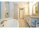 Bathroom featuring granite counters, double sinks, soaking tub, and a separate shower at 682 Canopy Estates Dr, Winter Garden, FL 34787