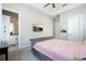 Bedroom featuring a tufted bed, TV, neutral decor, and access to an ensuite bathroom at 682 Canopy Estates Dr, Winter Garden, FL 34787