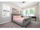 Comfortable bedroom with a tufted headboard bed, plantation shutters, and ample natural light at 682 Canopy Estates Dr, Winter Garden, FL 34787