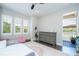 Light-filled bedroom with dark wood floors, shuttered windows, and access to a private balcony at 682 Canopy Estates Dr, Winter Garden, FL 34787