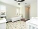 Neutral tone bedroom with crib, twin bed, ceiling fan, and shuttered windows for natural light at 682 Canopy Estates Dr, Winter Garden, FL 34787