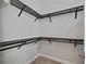 Walk-in closet featuring dark wooden shelving to provide space for storage of clothing and accessories at 682 Canopy Estates Dr, Winter Garden, FL 34787