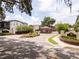 Community entrance featuring stone pillars, brick accents, and manicured landscaping at 682 Canopy Estates Dr, Winter Garden, FL 34787
