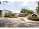 View of the community entrance with Canopy Oaks signage, well-manicured landscaping, and brick guardhouse at 682 Canopy Estates Dr, Winter Garden, FL 34787