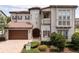 Beautiful two-story home featuring a tile roof, a turret entrance, and meticulously maintained landscaping at 682 Canopy Estates Dr, Winter Garden, FL 34787