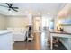 Flex space with desk, dividing bookshelves, and view of living room space with white sectional at 682 Canopy Estates Dr, Winter Garden, FL 34787