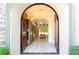 Grand foyer with arched doorway, chandelier, display cabinets, and views into the living area at 682 Canopy Estates Dr, Winter Garden, FL 34787