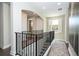 Upper hallway featuring dark wood floors, detailed railings, and view to the outside at 682 Canopy Estates Dr, Winter Garden, FL 34787