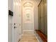 Hallway with a built-in mudroom area, arched doorway, and stylish decor, leading to the main living spaces at 682 Canopy Estates Dr, Winter Garden, FL 34787